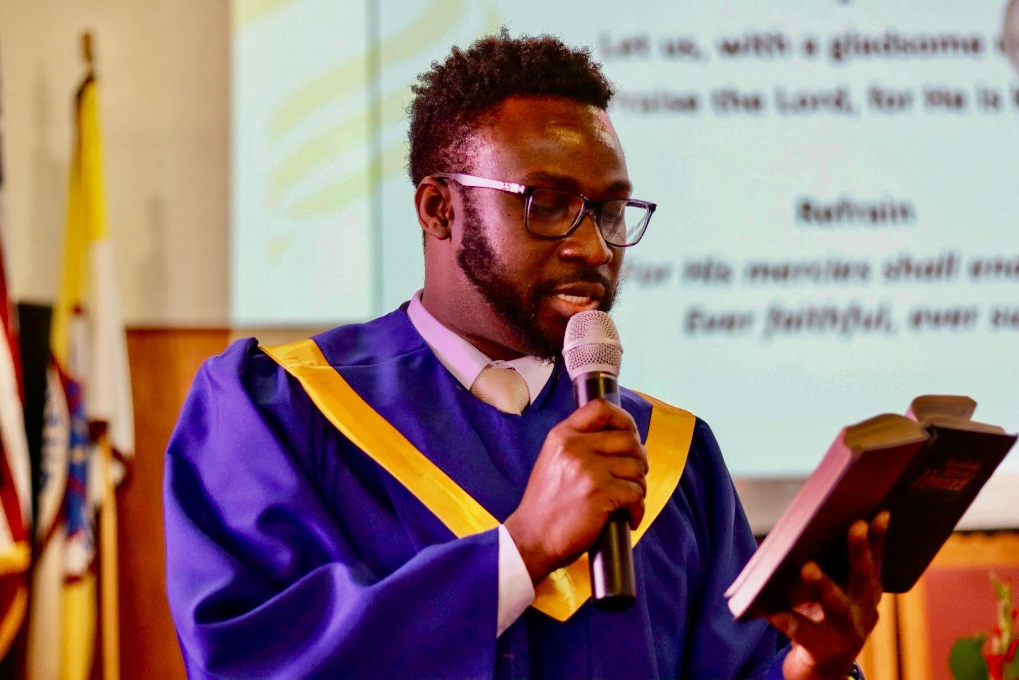 Choir director leading worship with hymnal